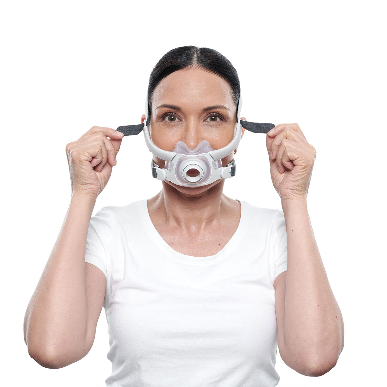 A woman tightening the straps of the AirFit F40 CPAP Mask